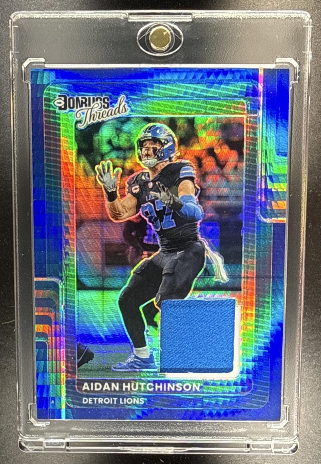116_2025_PANINI_DONRUSS_OPTIC_AIDAN_HUTCHINSON_DTBH_AHT_THREADS_BLUE_PRIZM_MEM.jpg