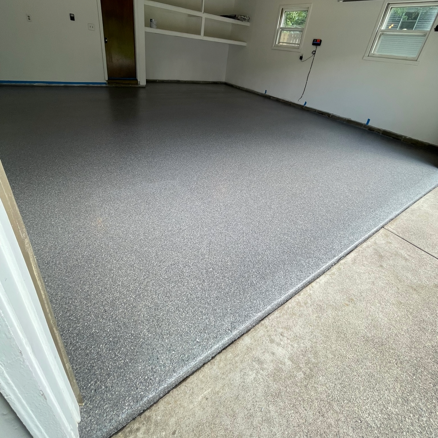 Residential  two car garage with new epoxy floor coating and white painted walls