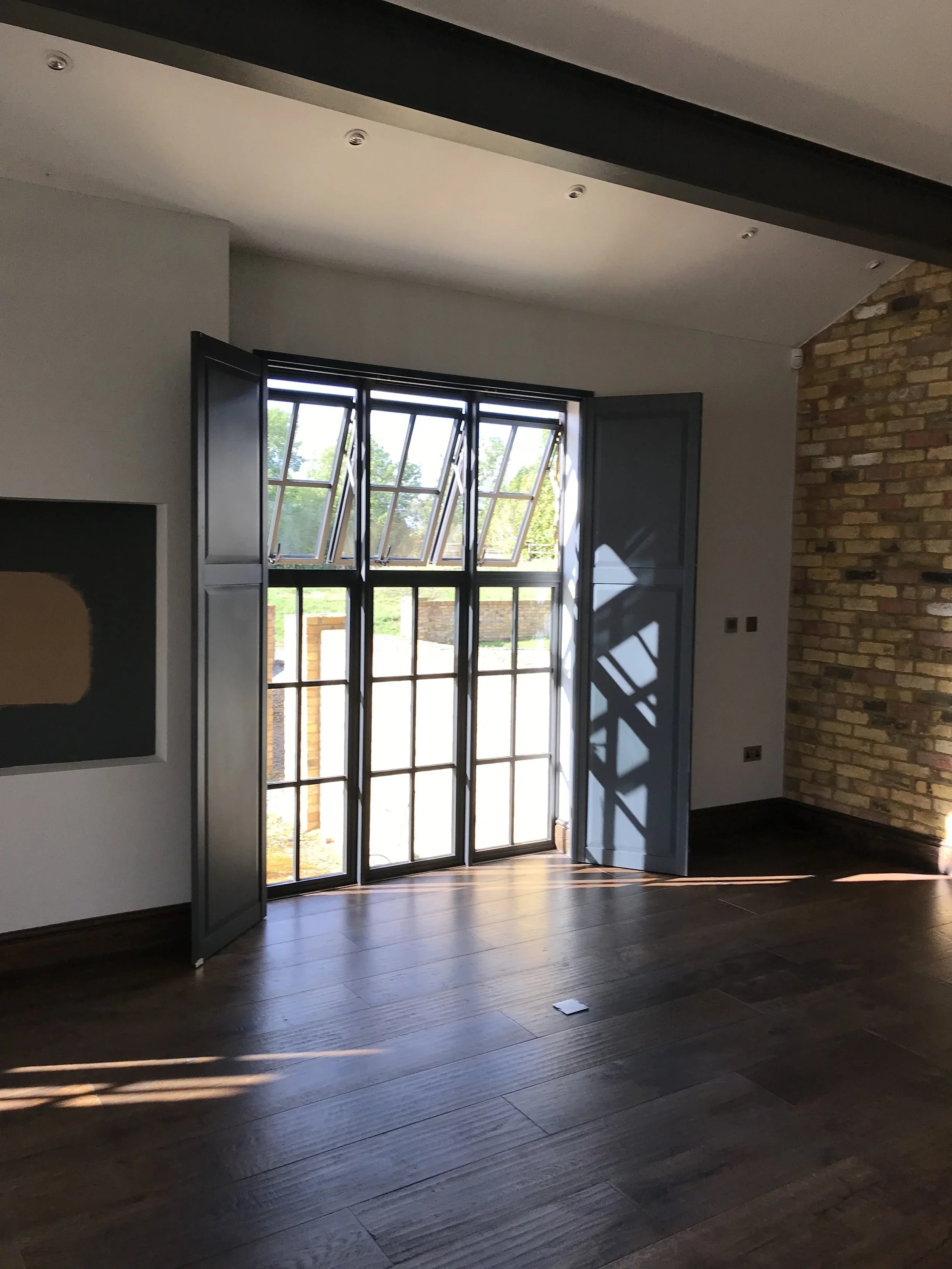 Solid panel shutters open patio door