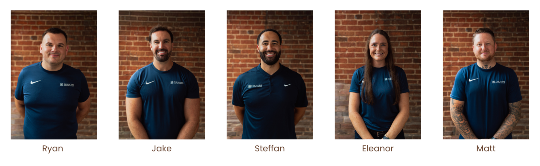 Five people standing in front of brick wall, wearing blue shirts with logo. From left to right: male, male, male, female, male with tattoos, all smiling.