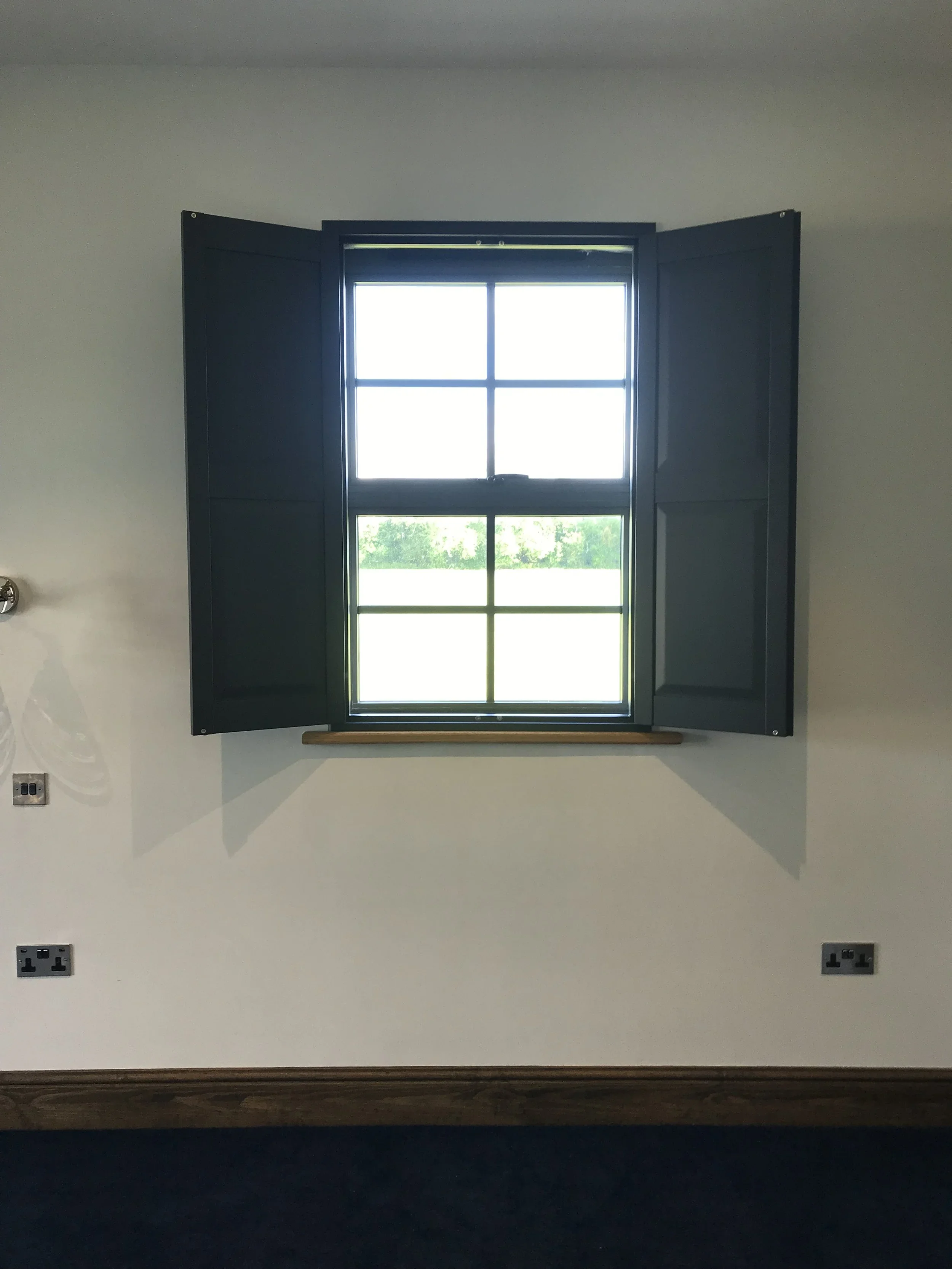 Black solid panel shutters open