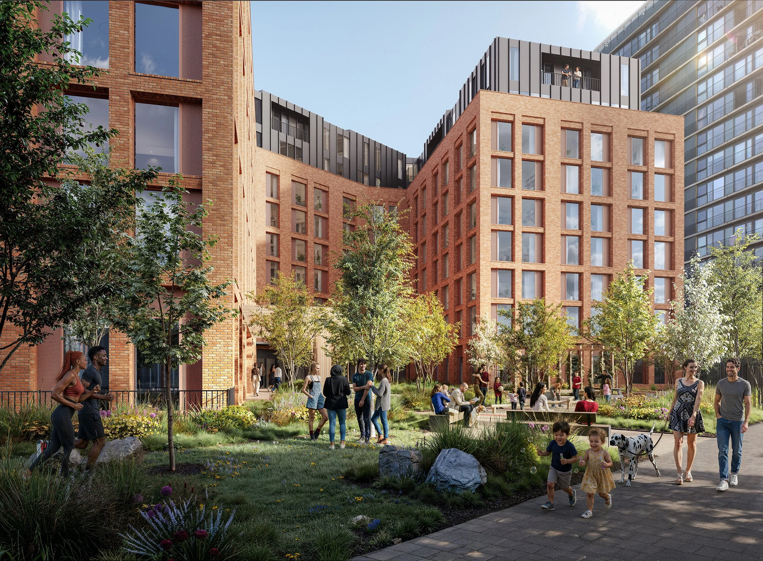 People walking, talking, and playing in a landscaped urban park area surrounded by modern brick and glass apartment buildings on a sunny day.