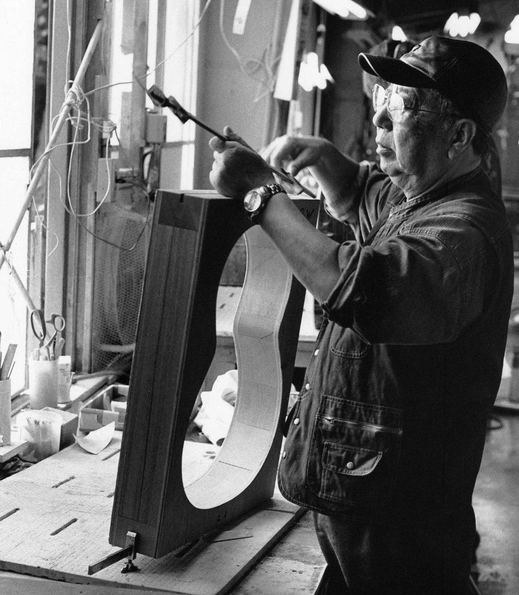 Mr Kazuo Yairi is working on a guitar with a template