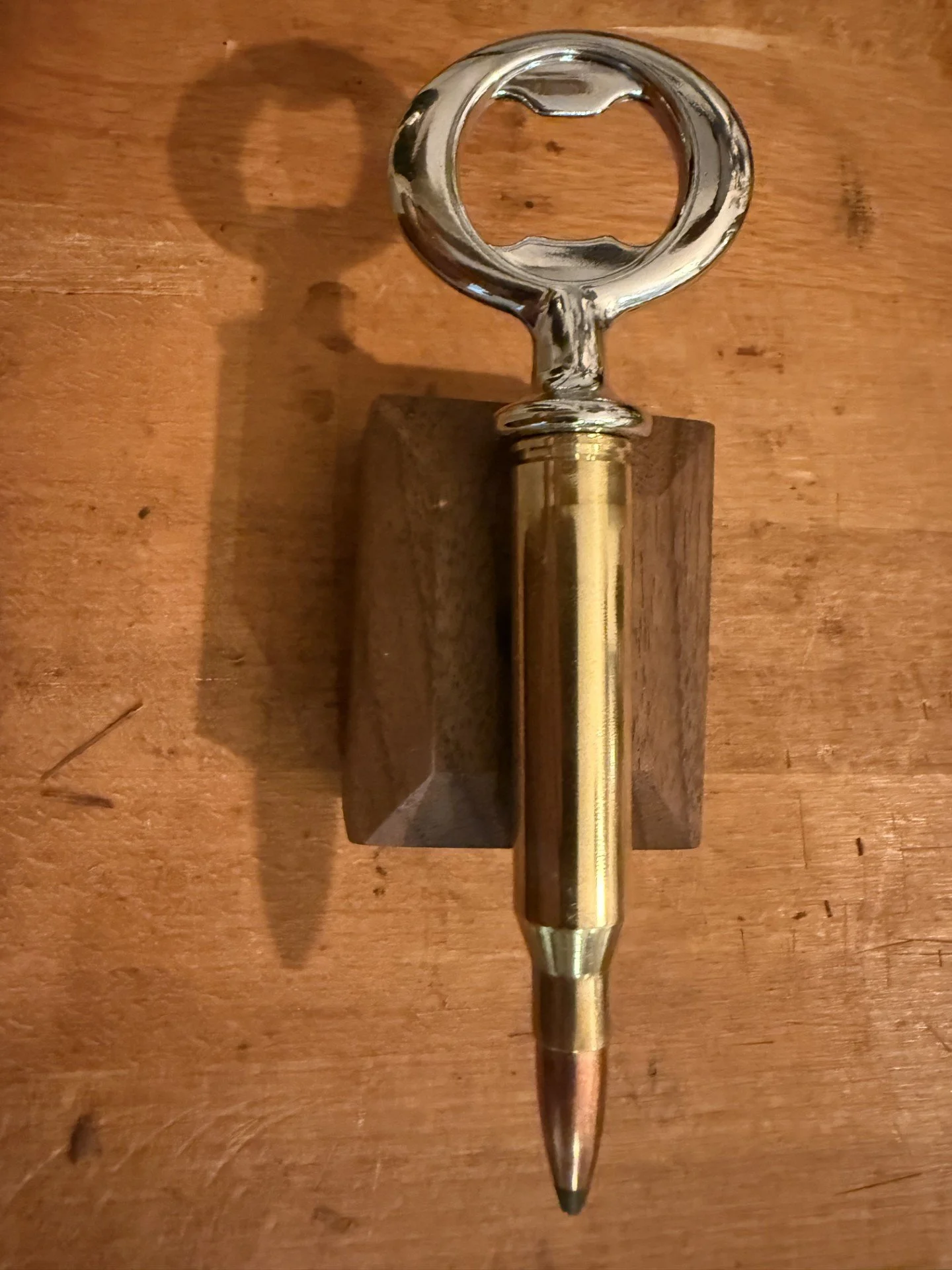 A bottle opener made with a once fired .338 Laupu casing with the a bullet replaced in it.