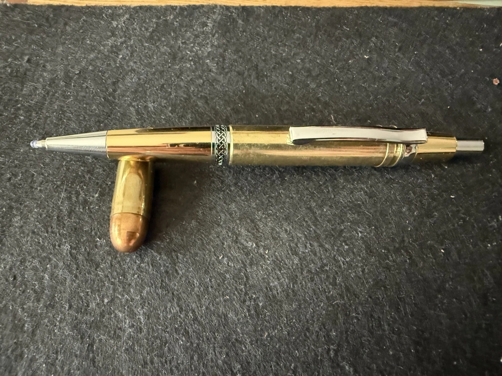 .300 MEN click pen in gold.
