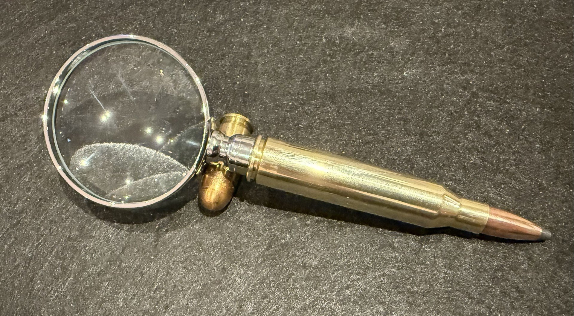 A magnifying glass made with a once fired .338 Lapua casing with a bullet reseated in the casing.