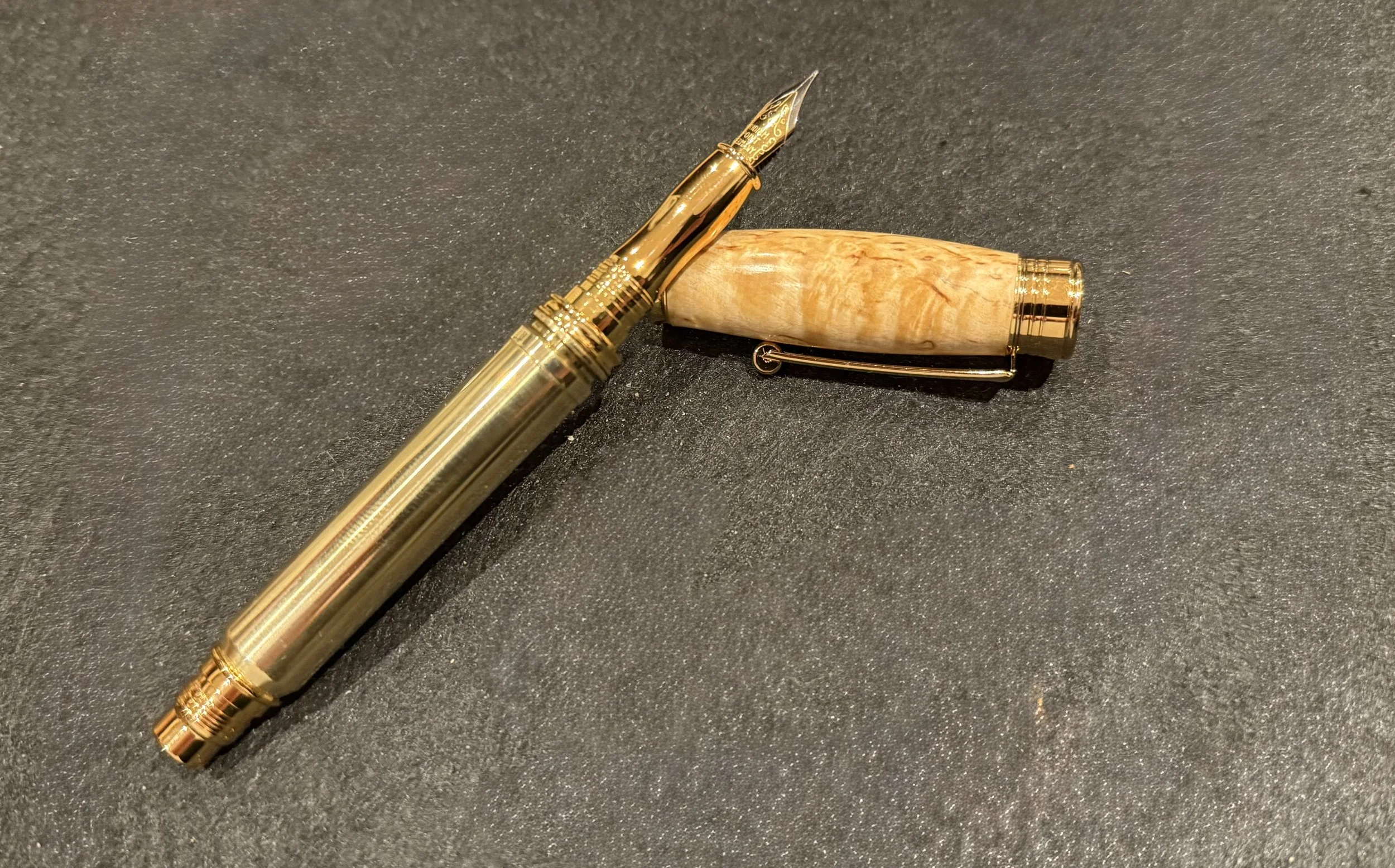 A fountain pen made with a 300 MEN casing and a piece of Masur Birth which shows some beautiful figure.
