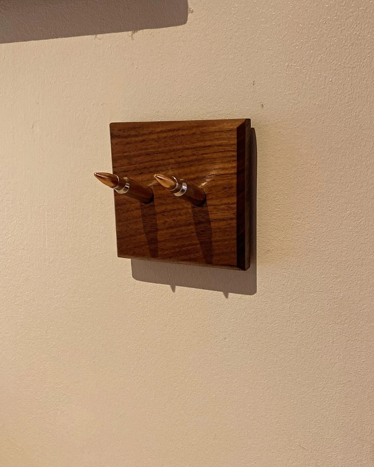 Key hooks made from a piece of Black Walnut and two once fired .308 nickel coated casings with bullets reseated.