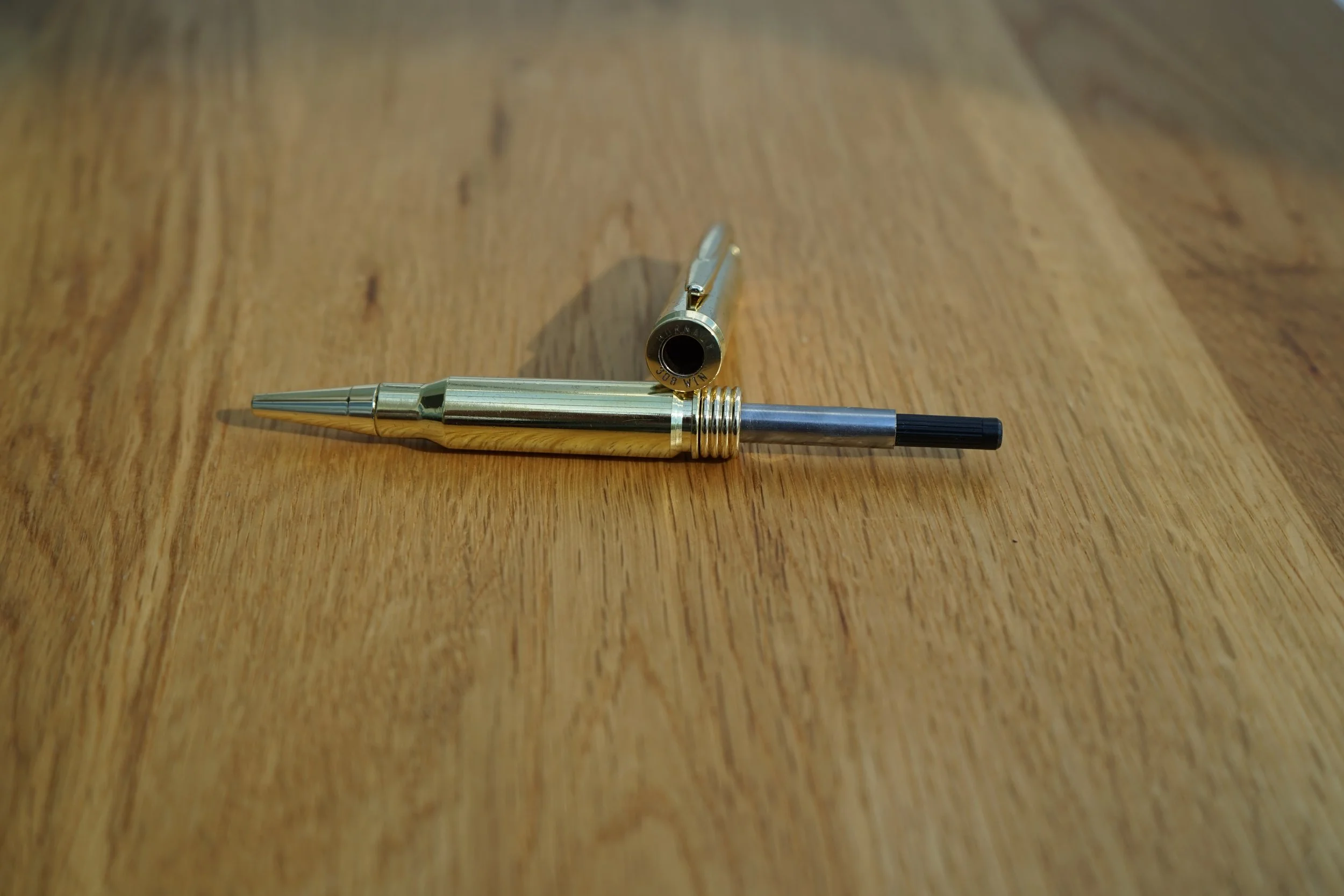 A 308 EDC pen separated so that the refill can be replaced.