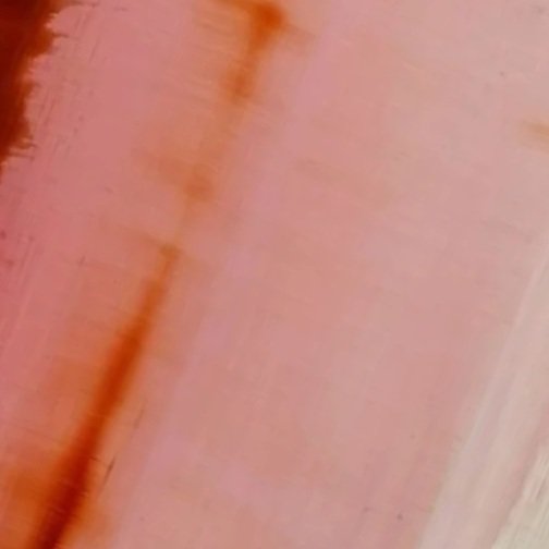 Close-up of a peach-colored wall with subtle texture and shading.