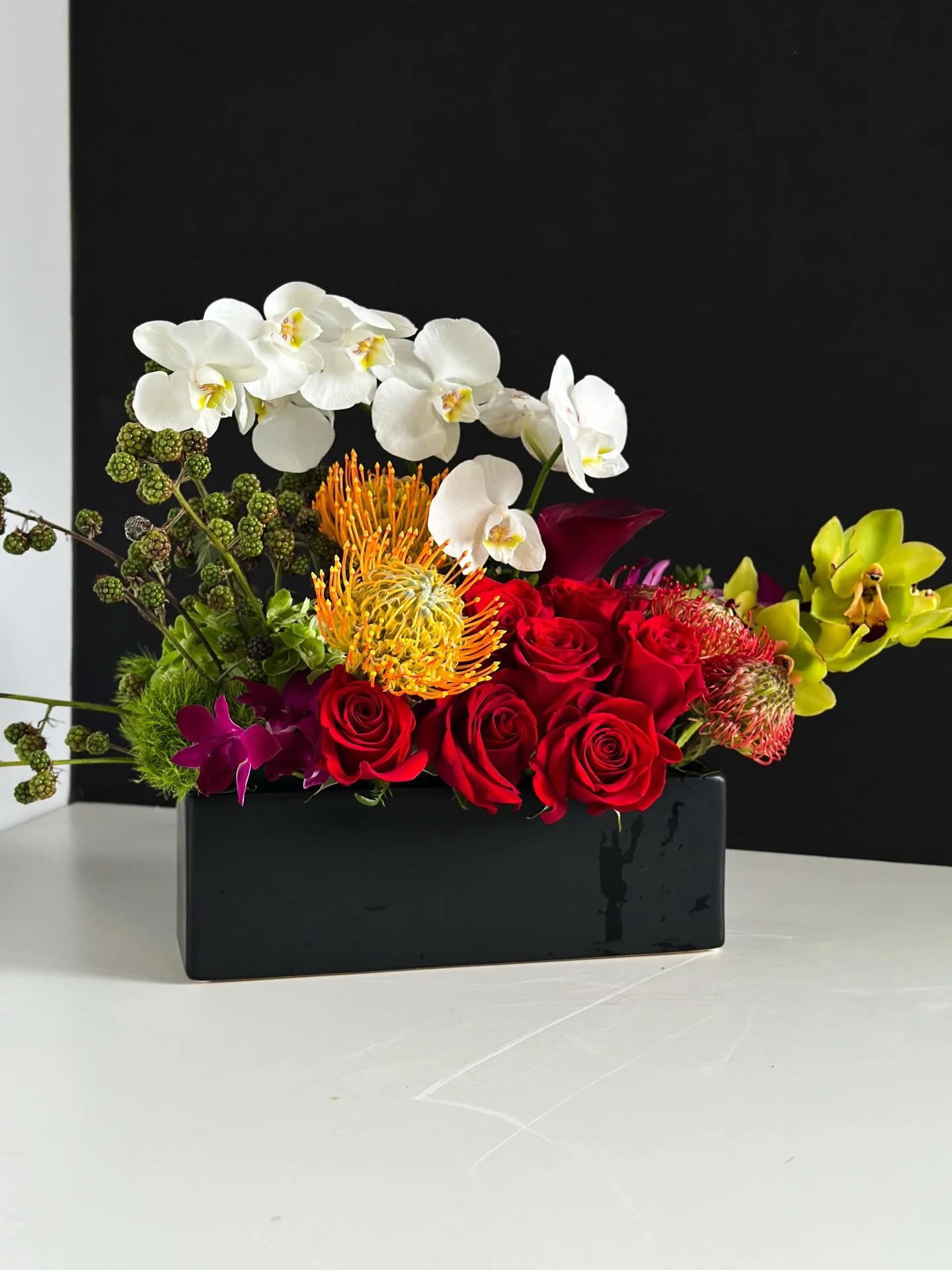 This custom arrangement we did over the weekend for Valentine&rsquo;s Day was stunning, we had to share it. It features red roses, Phalaenopsis Orchids, Cymbidium Orchids, Pincushion Protea, Calls Lillys, and supporting greenery.