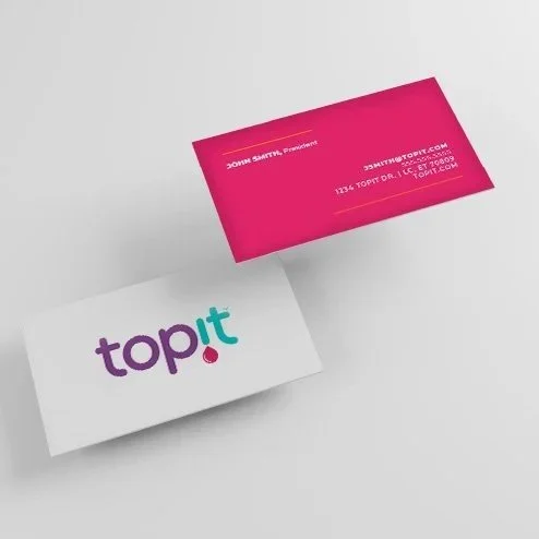 Business cards on a white surface, one pink and one white, with the word 'topit' on the white card and contact information on the pink card.