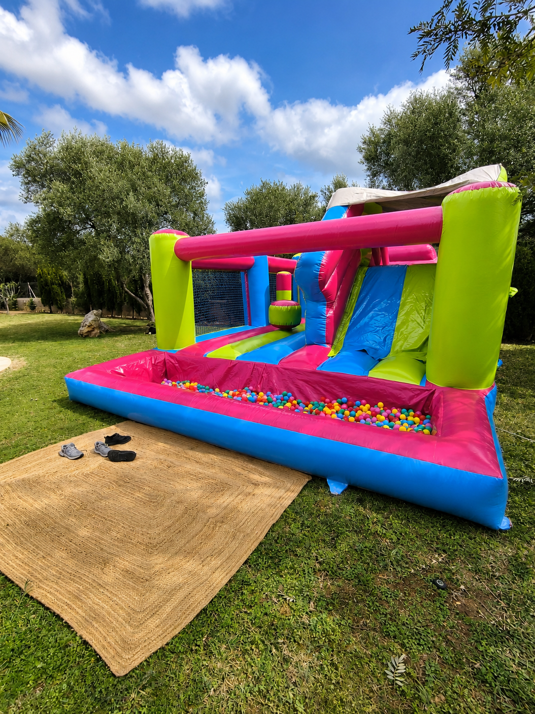 Multicoloured bouncy castle with ball pit and slide for a kids’ birthday party in Sa Cabaneta, Mallorca