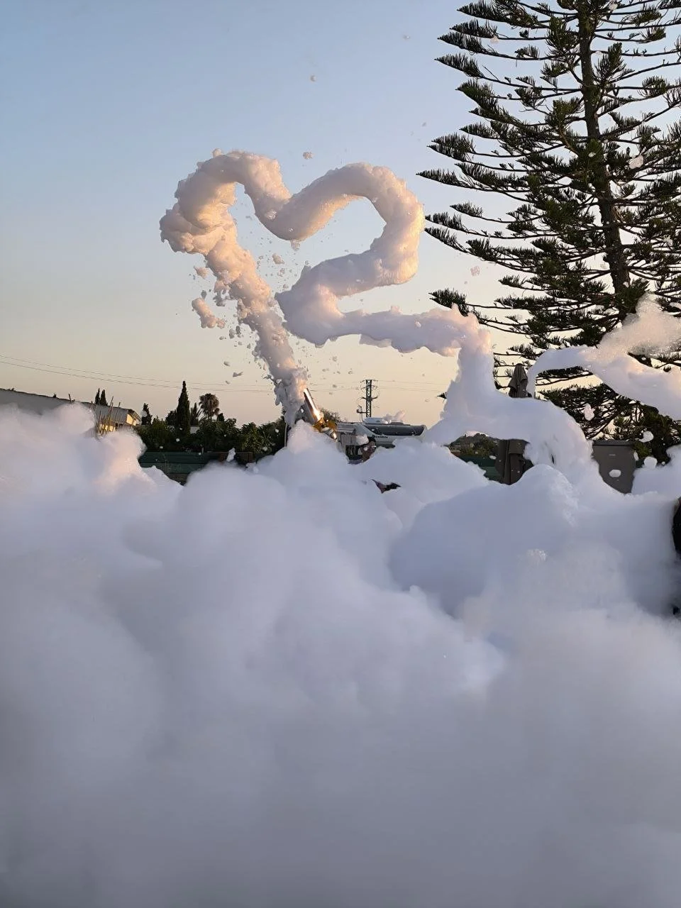 Professional kids animator Ivan drawing a heart shape in the air with foam at an exciting children's foam party in Mallorca by Norivan Kids Entertainment.
