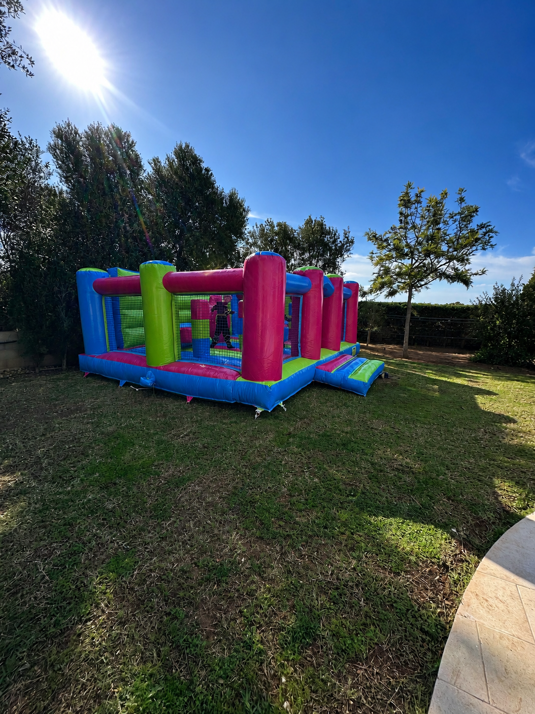 Multicolour bouncy castle rental for a private garden party in Mallorca