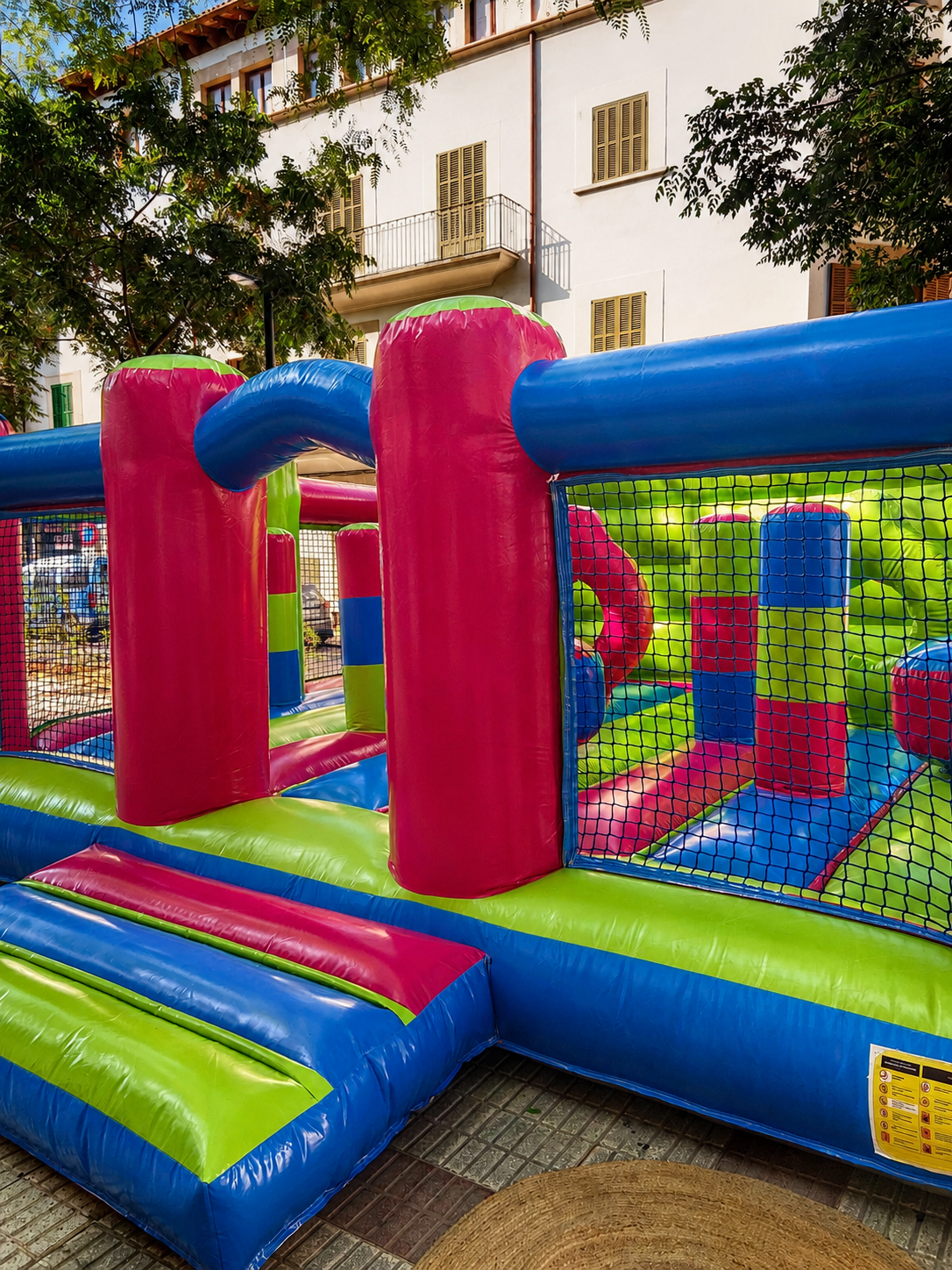 Multicolour bouncy castle rental for a charity event in Inca, Mallorca