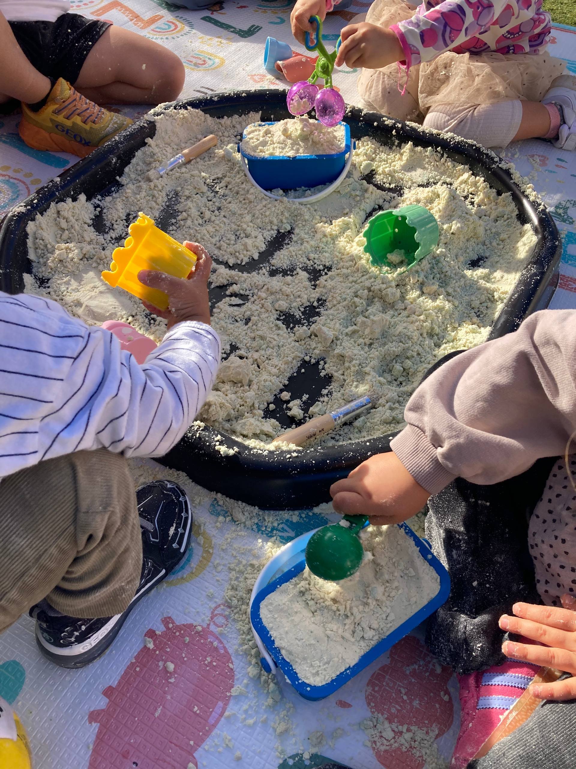 Toddlers enjoying sensory play with sensory bins in Alaró, Mallorca