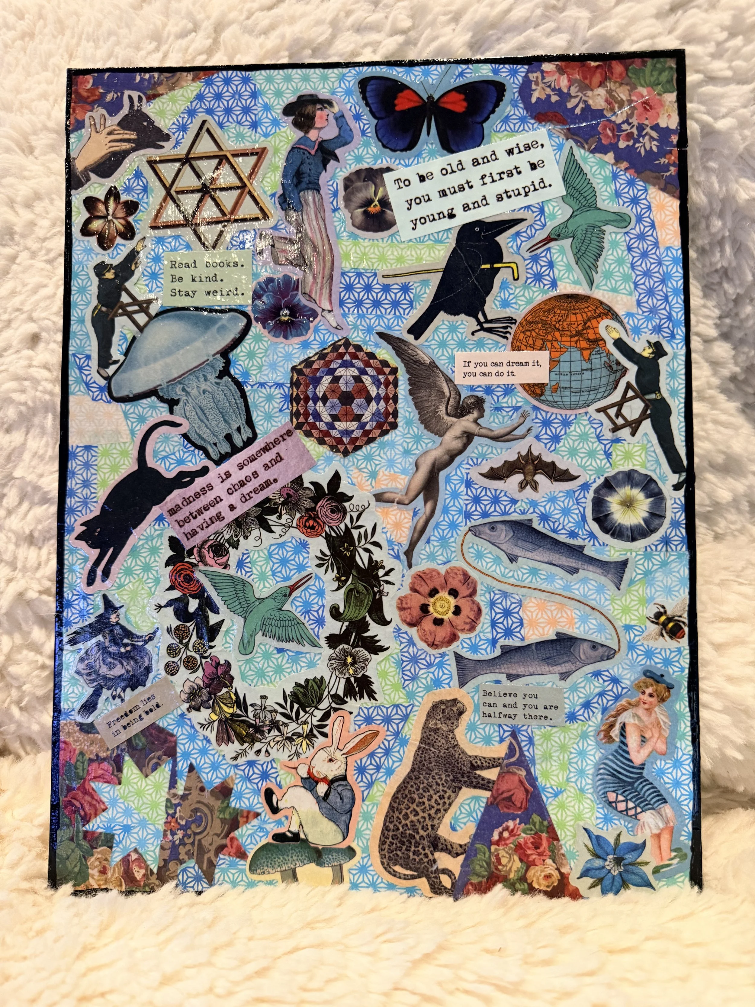 Collage of various cut-out images and inspirational quotes, including a butterfly, a woman, a raven, a globe, a rabbit, a fish, flowers, and other nature and fantasy-themed illustrations.