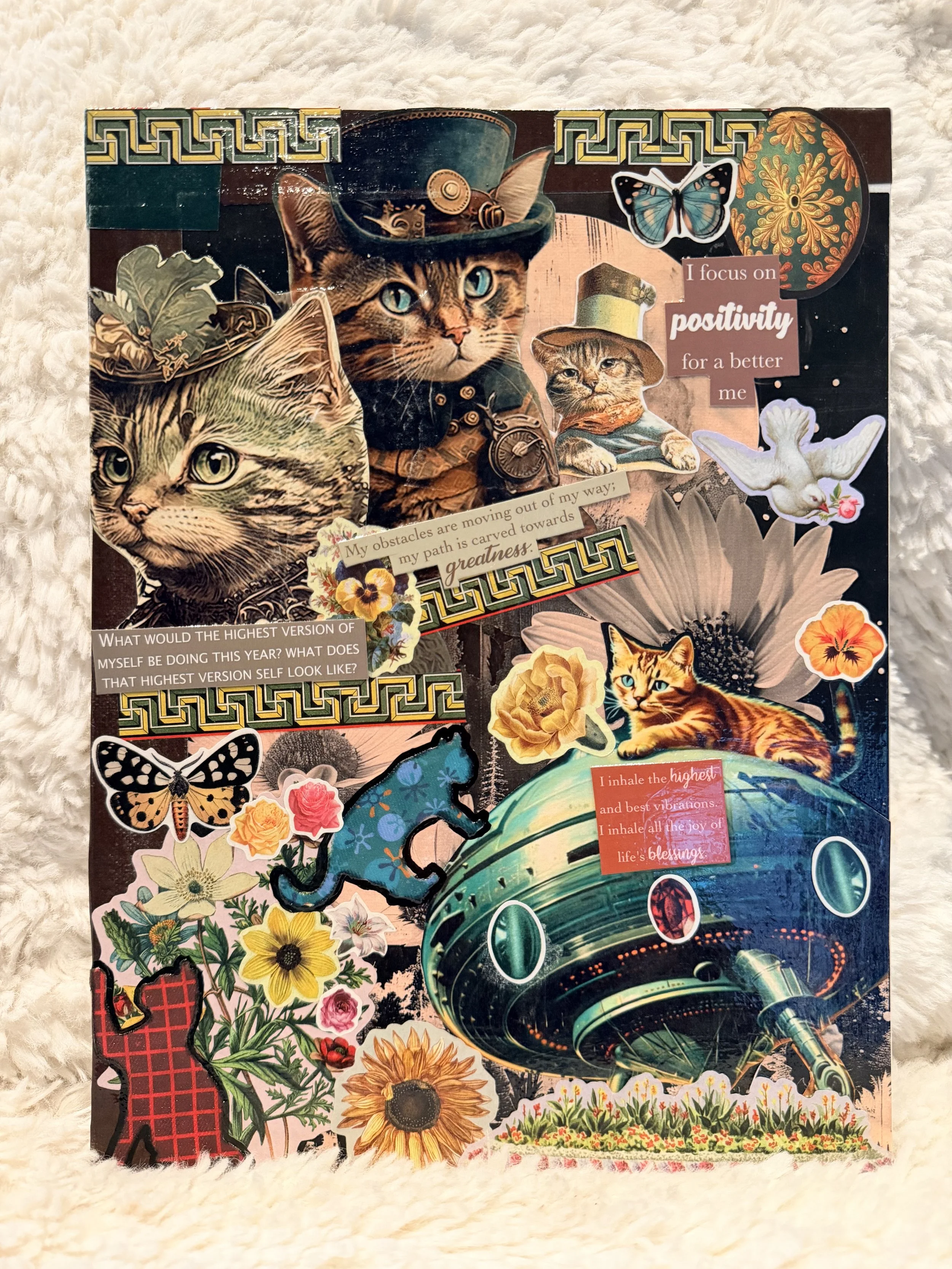 A collage of various images and text cutouts including cats, butterflies, flowers, and inspirational quotes, arranged on a colorful background.