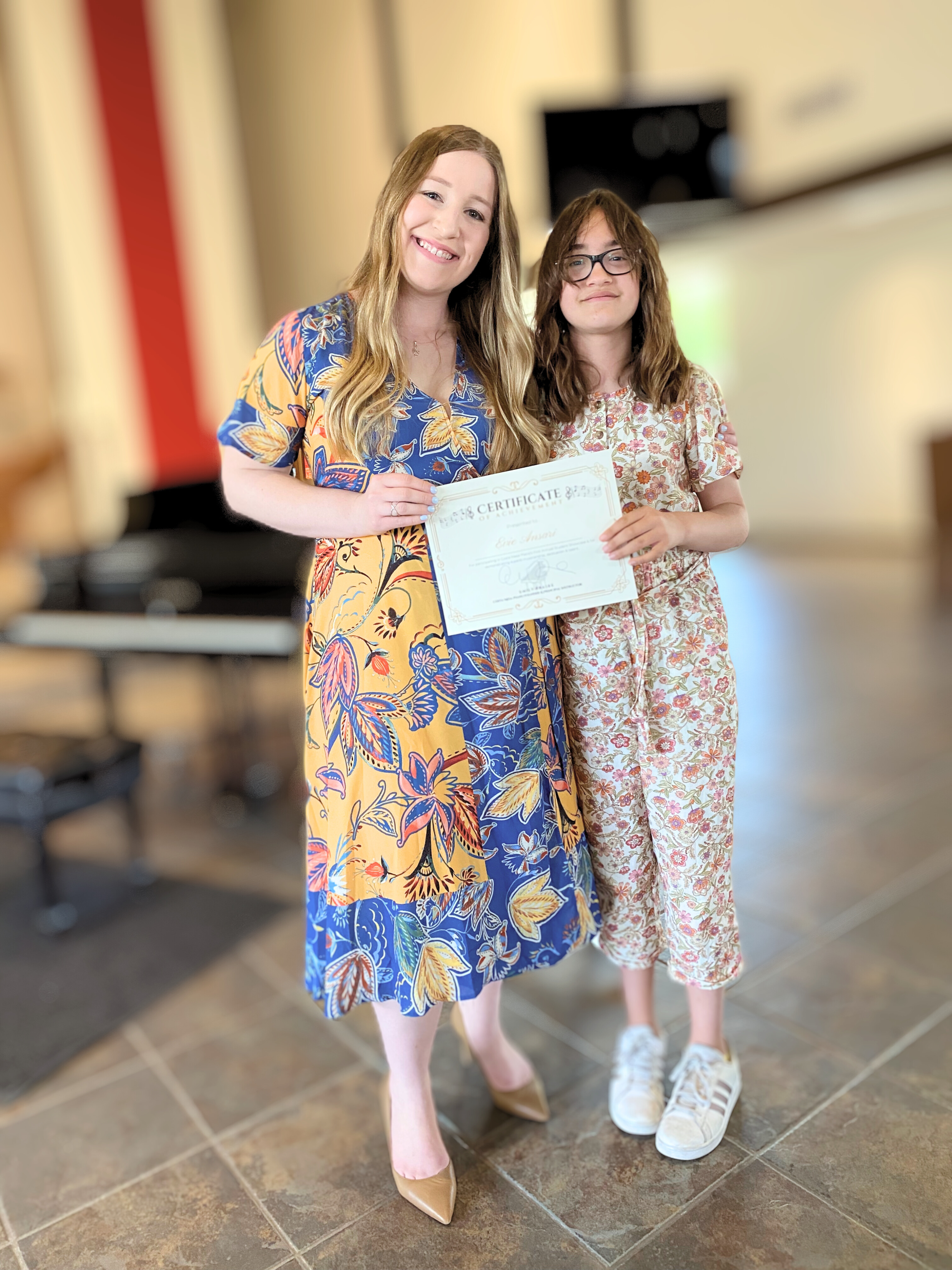 Emily and her student at a recital