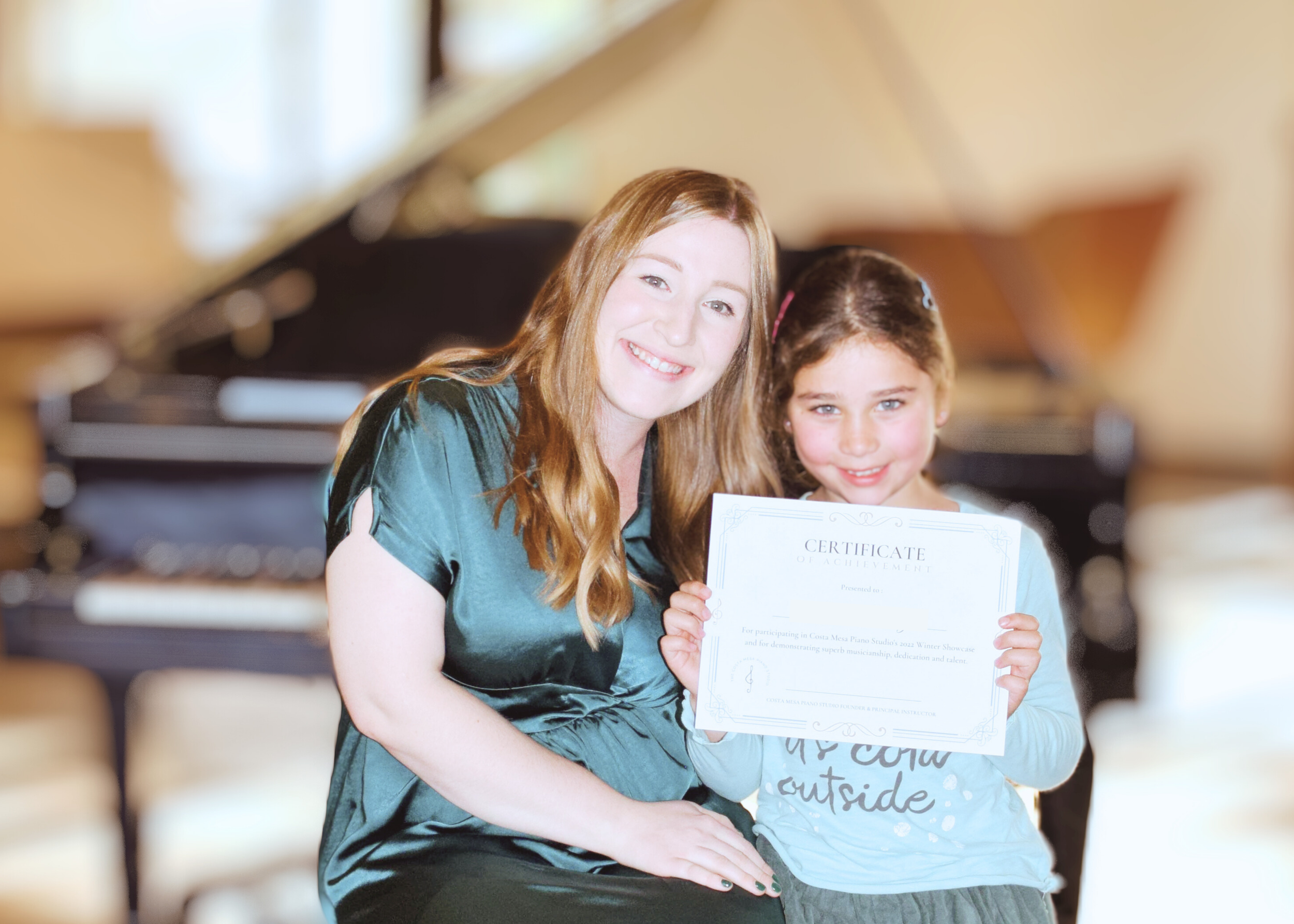 Emily and her student at a recital