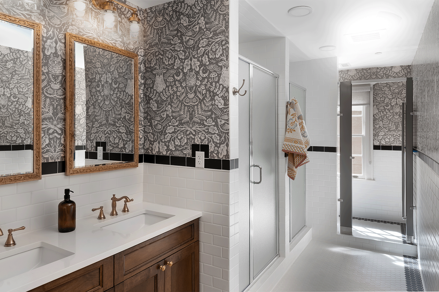 Bathroom with whimsical woodland creative wallpaper and double vanity.