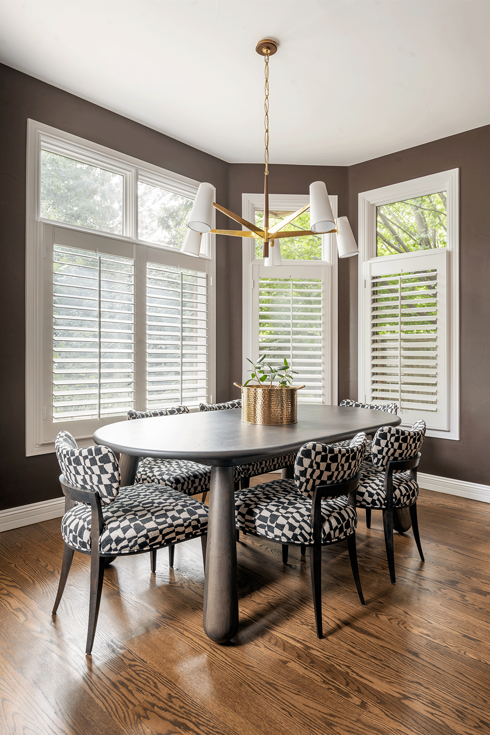 Dining table with over-scaled club legs paired with delicately bold dining chairs.