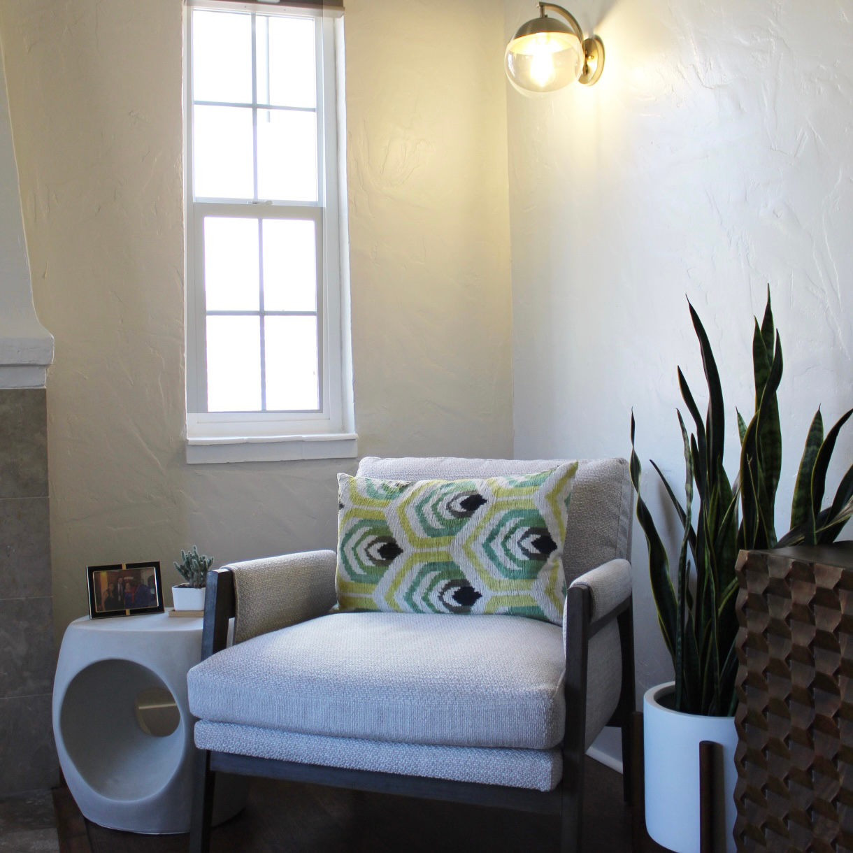 Side chair with graphic accent pillow.