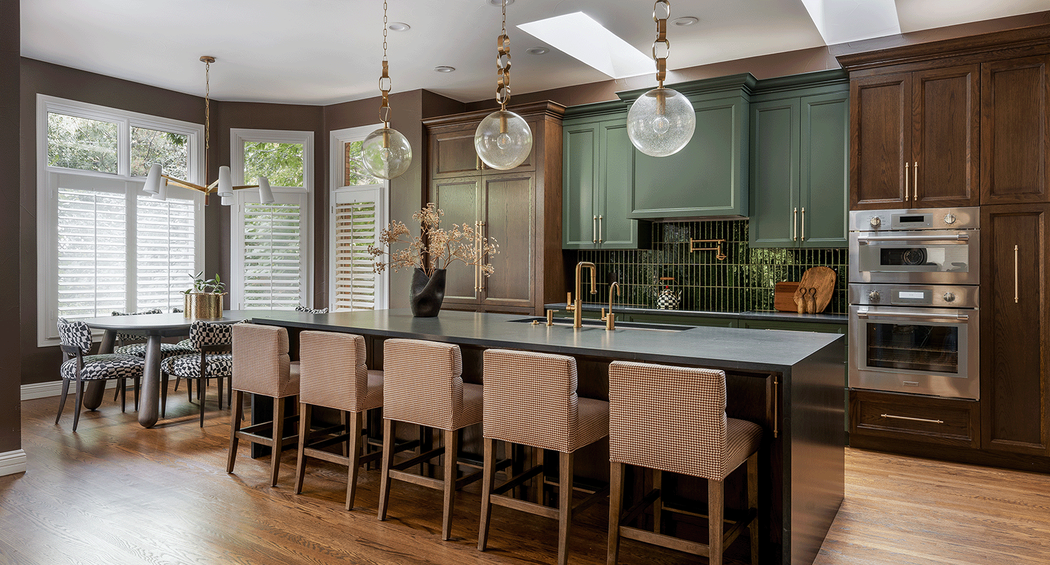 Contemporary kitchen featuring two saturated cabinet finishes, emerald green tile backsplash and statement pendants.