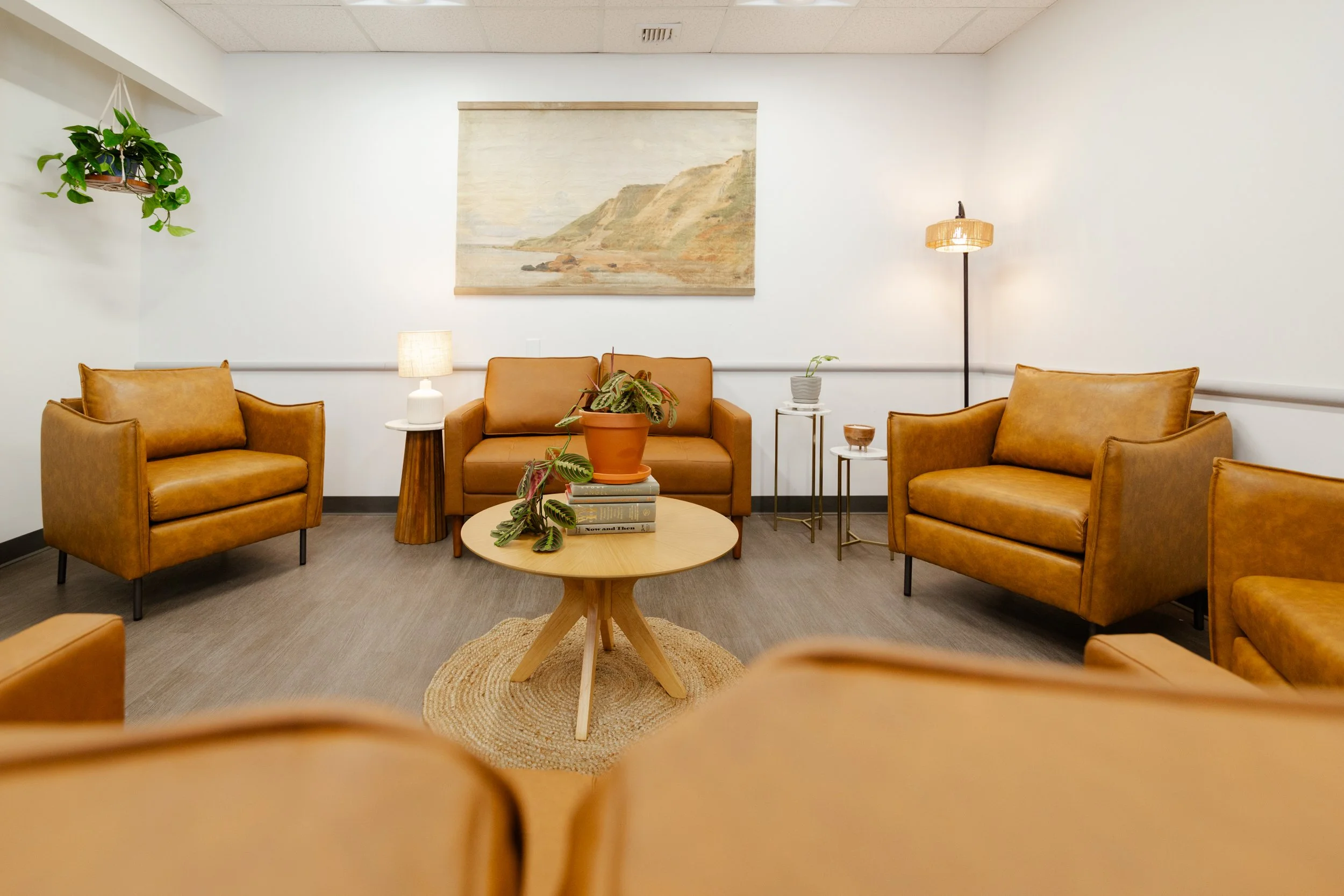 Waiting room with four tan leather armchairs