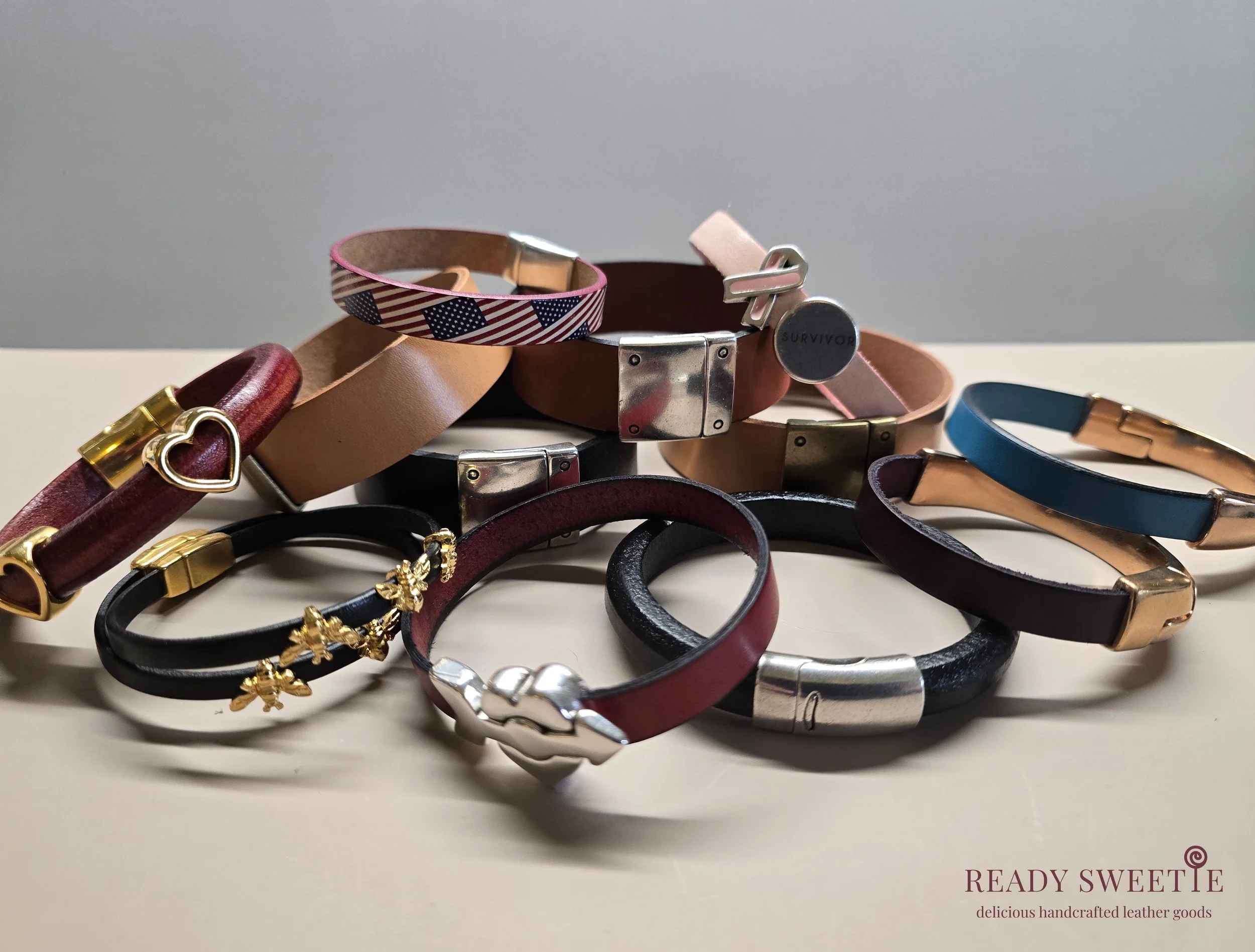 Collection of handmade leather bracelets with various clasps and designs, by Ready Sweetie