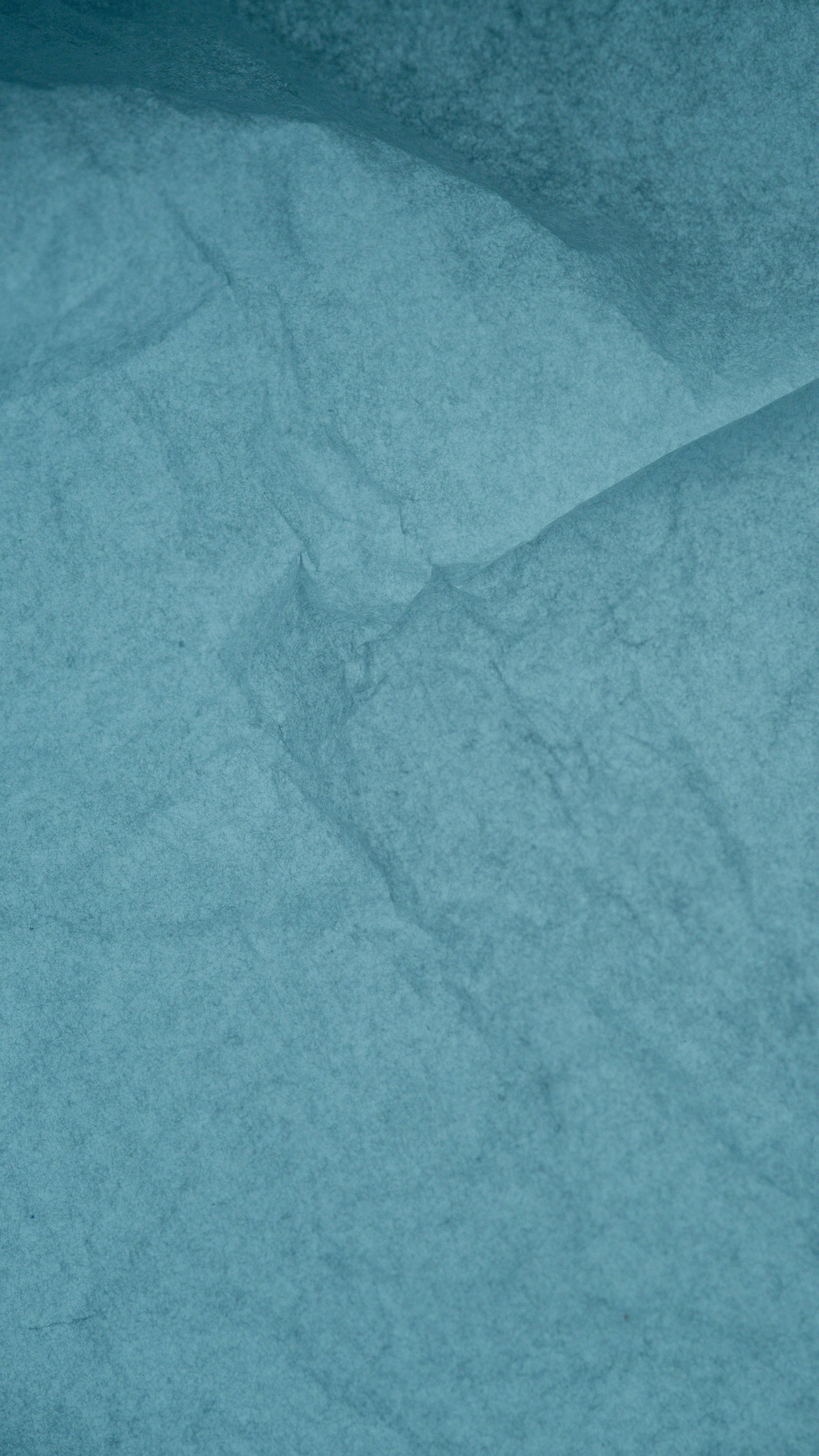 Close-up of crumpled blue tissue paper.