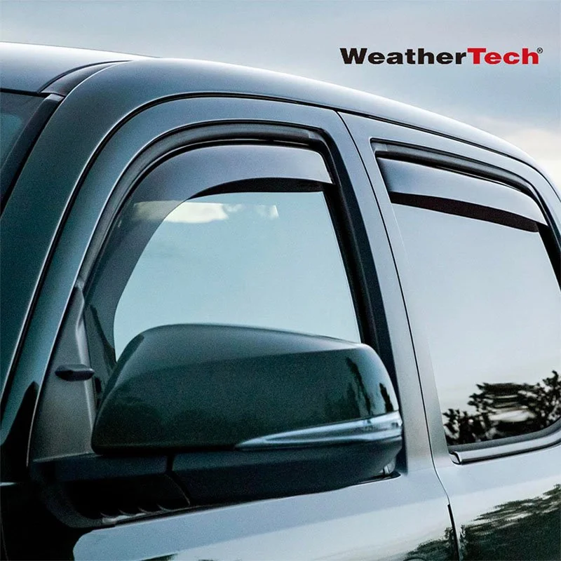 Close-up of a modern pickup truck's side mirror and window, with the WeatherTech logo in the top right corner.