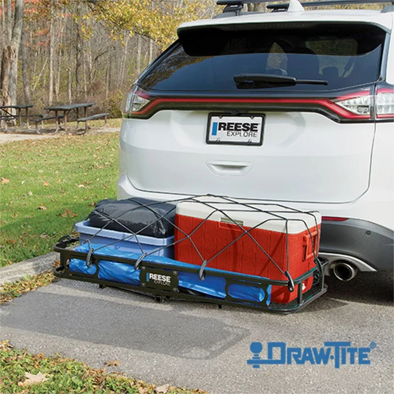 Reese Explore hitch-mounted cargo carrier transporting a cooler and a bag in a parking lot.
