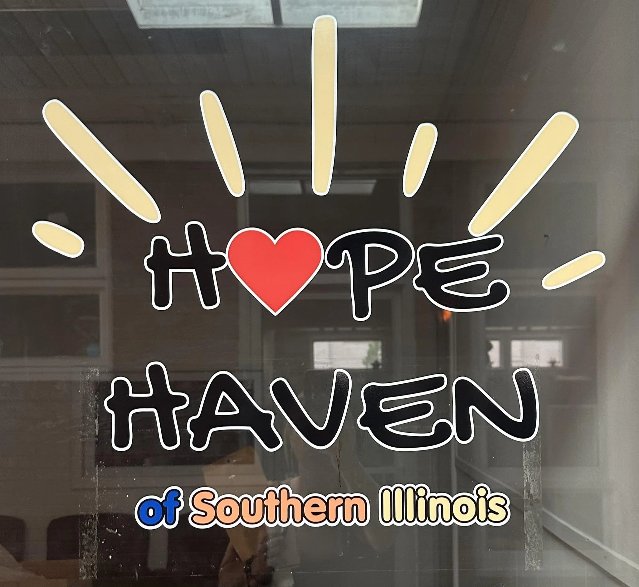 Sticker with the words "HAPPY OF southern Illinois" with colorful text and a red heart in the middle of the word "HAPPY."