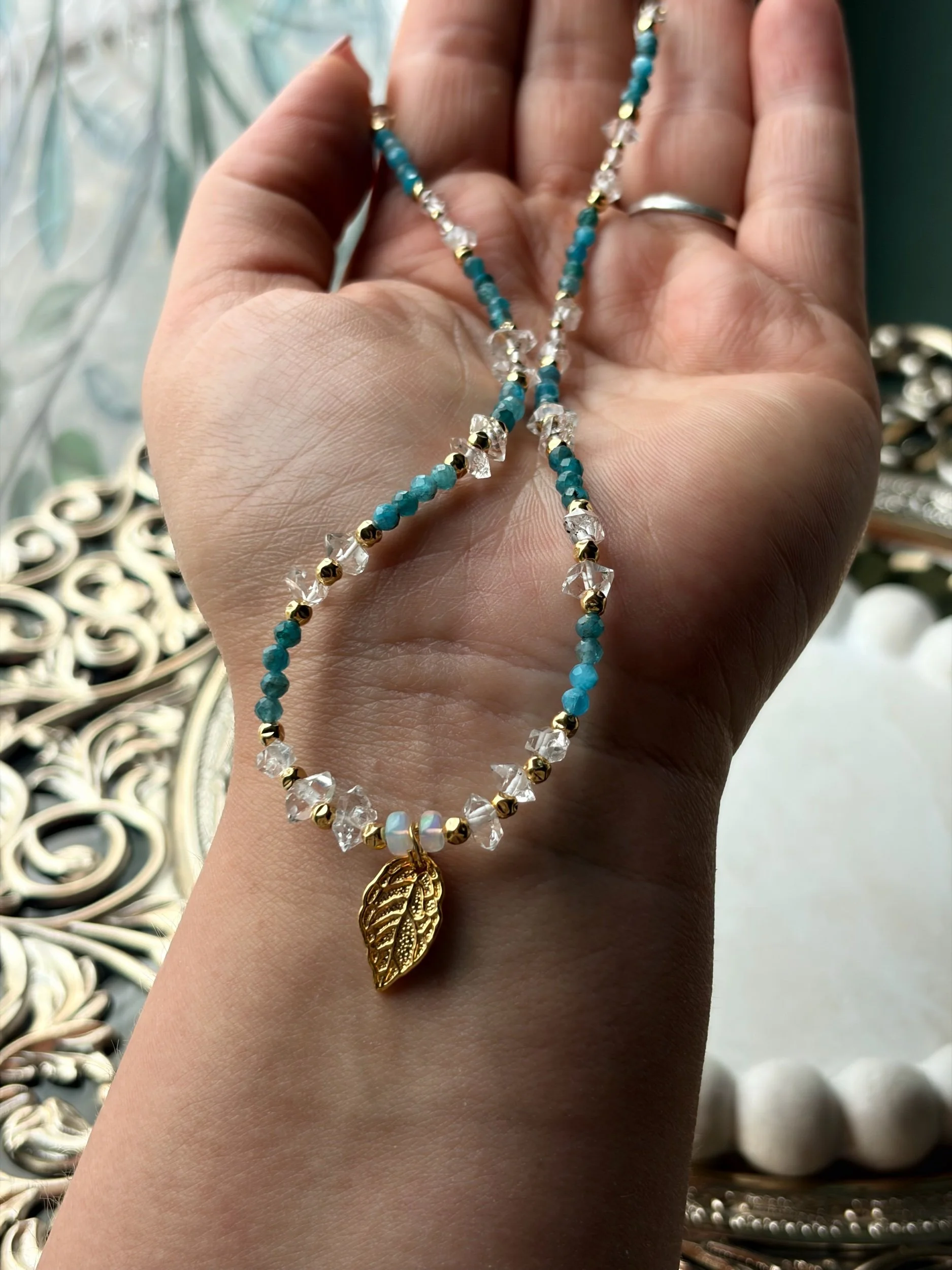 Opal Kette AURELIS mit Apatit und Herkimer-Diamanten auf der Hand