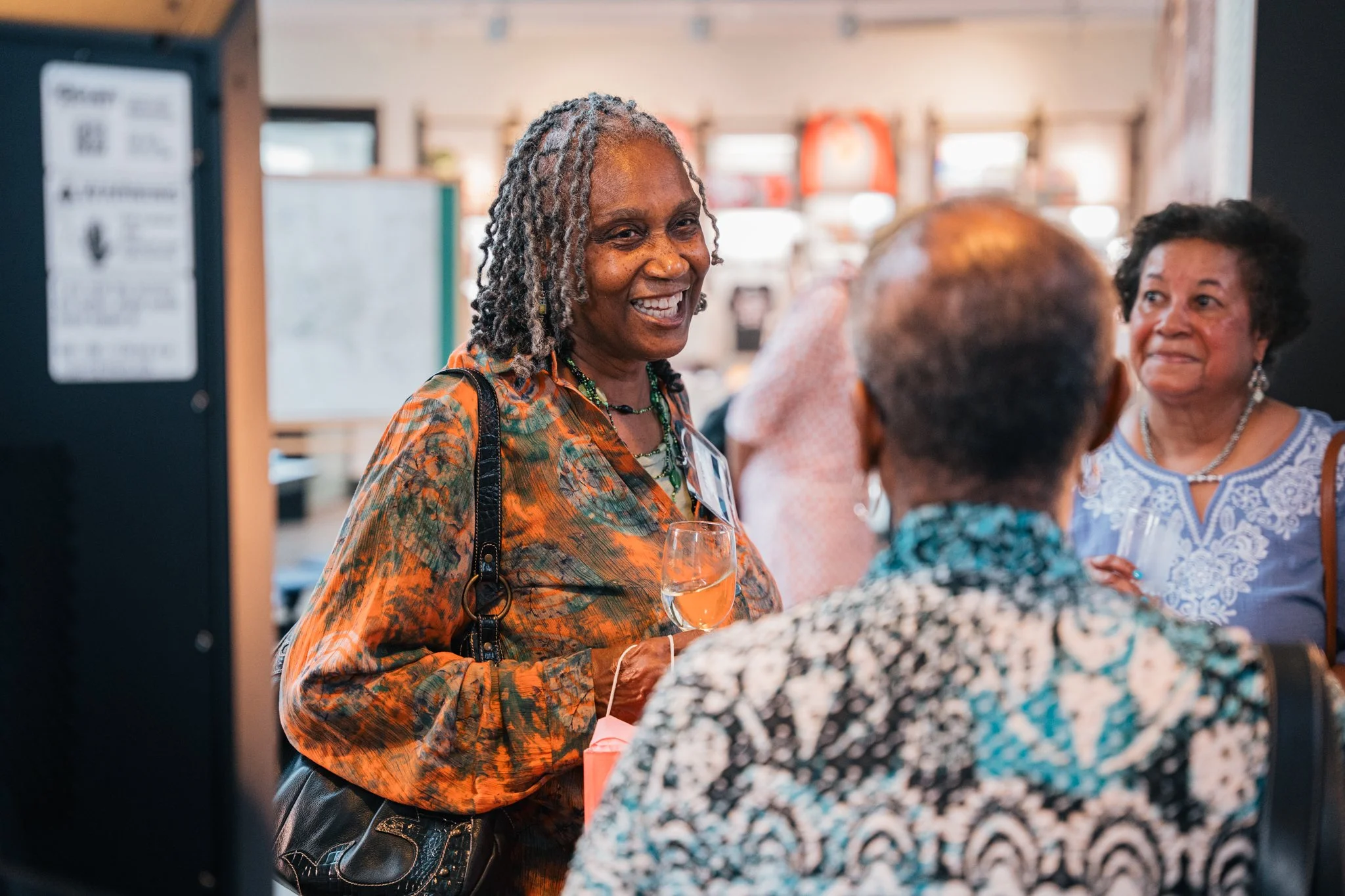 Narrator Patricia Wheeler speaking with other attendees during the opening event.

Photo by Cindy Centeno