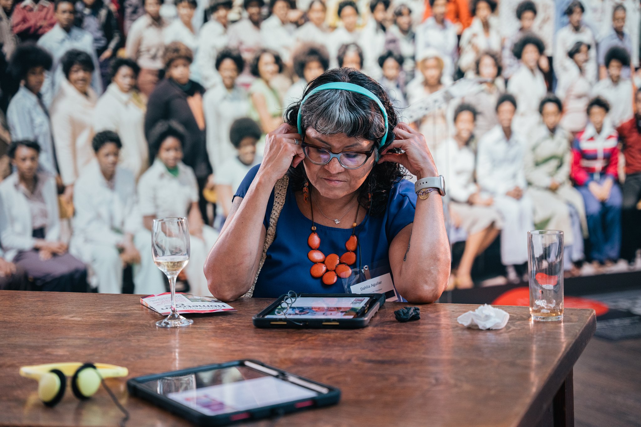 Narrator Dahlia Aguilar listening to hometown DC oral histories in the opening reception's Listening Lounge.

Photo by Cindy Centeno