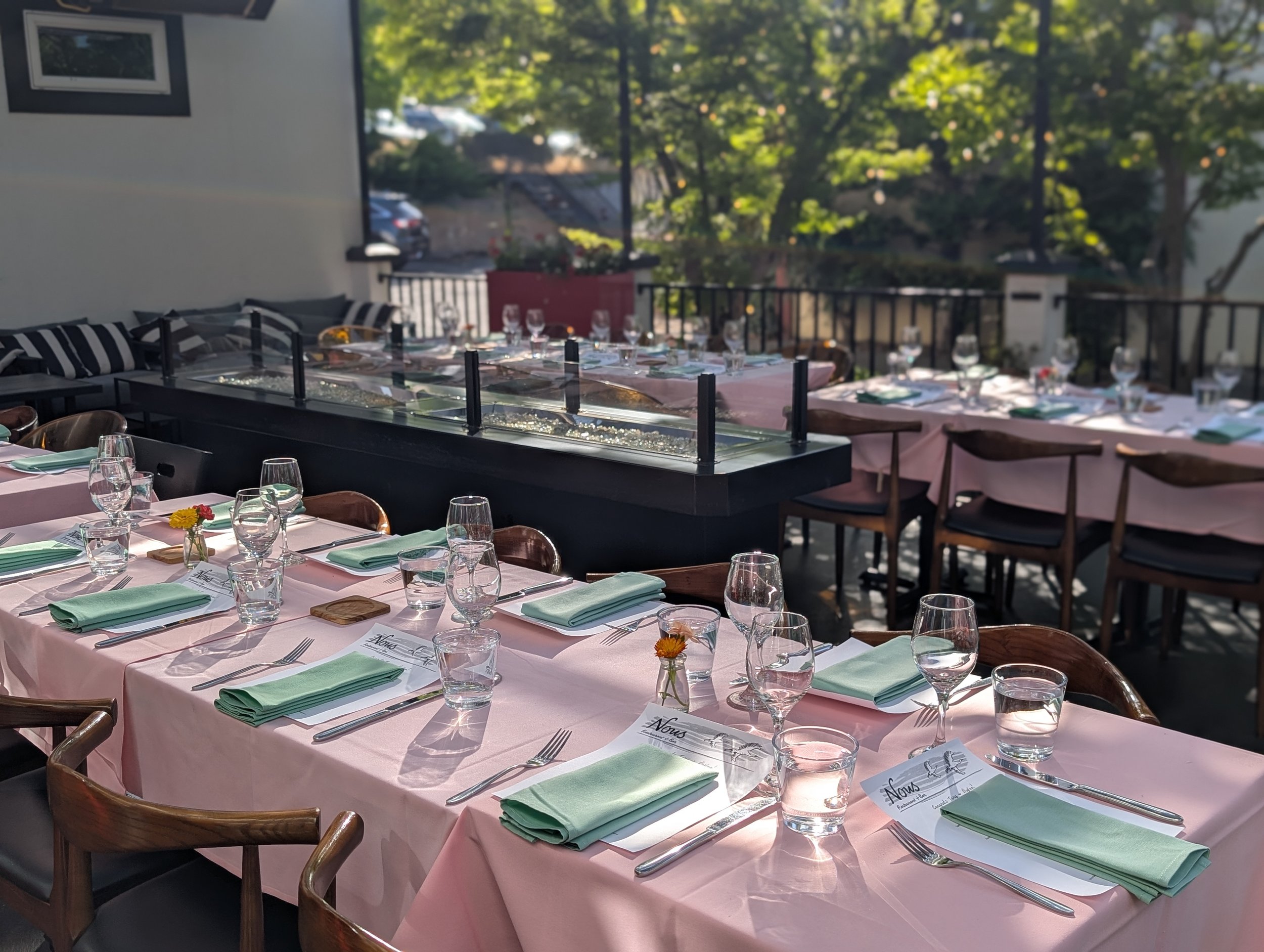 Spacious outdoor seating awaits your party on Nous' sunny and dig friendly patio. Shaded tables and sidewalk adjacent seating is available.