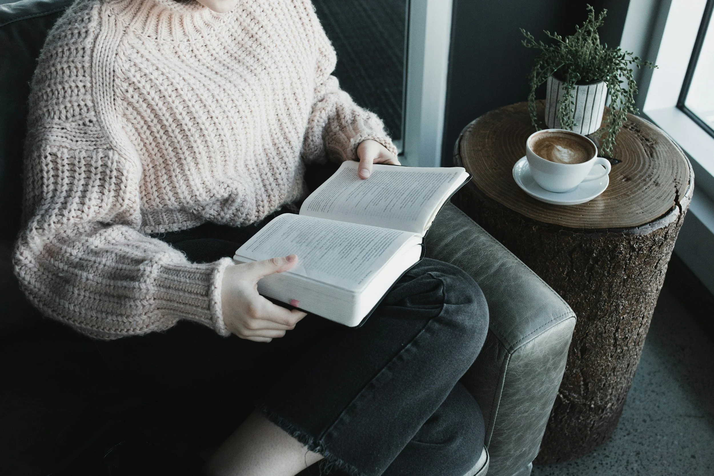 woman sitting on a chair reading the bible