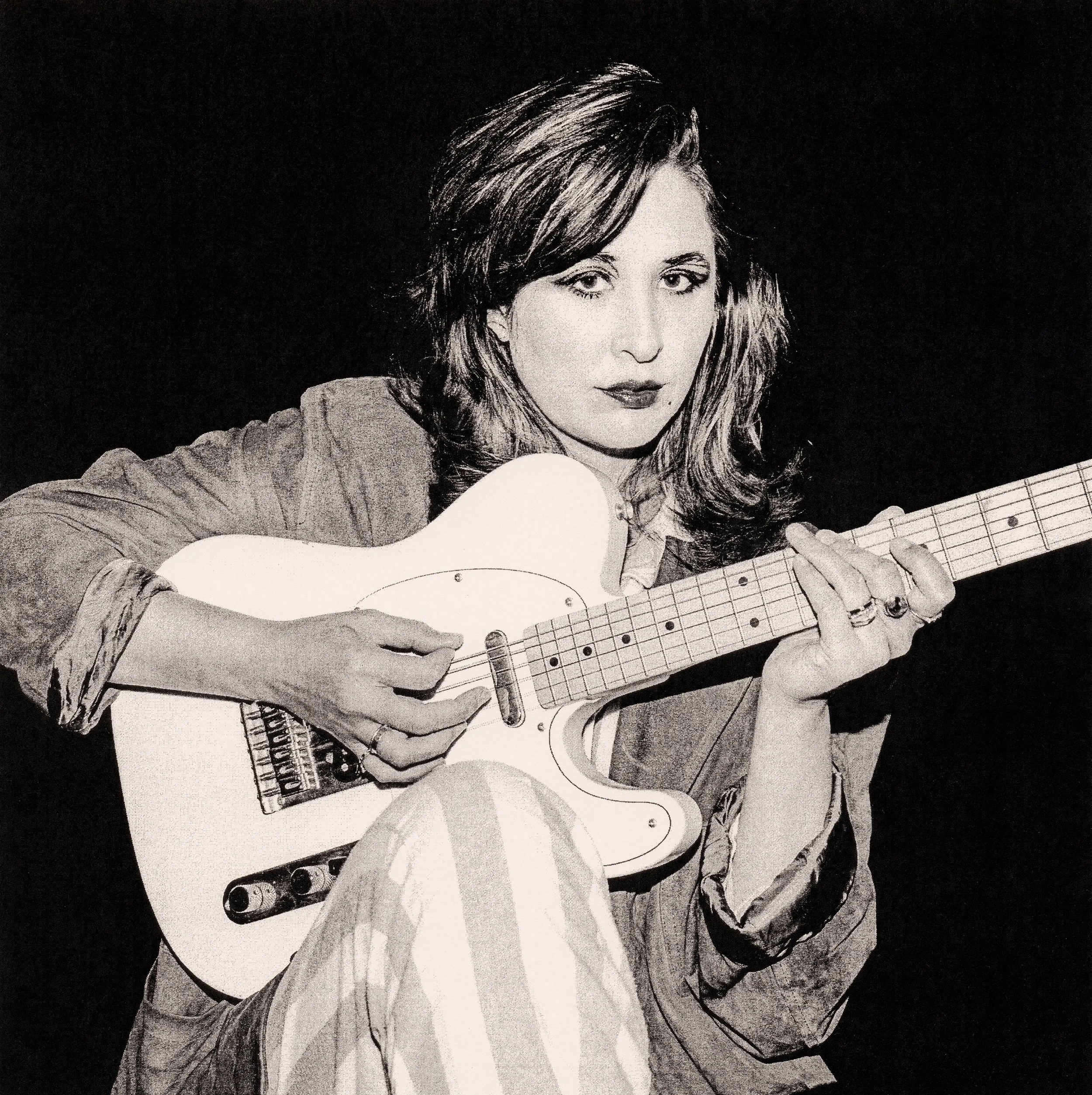 Black and white drawing of a woman with wavy hair playing an acoustic guitar.
