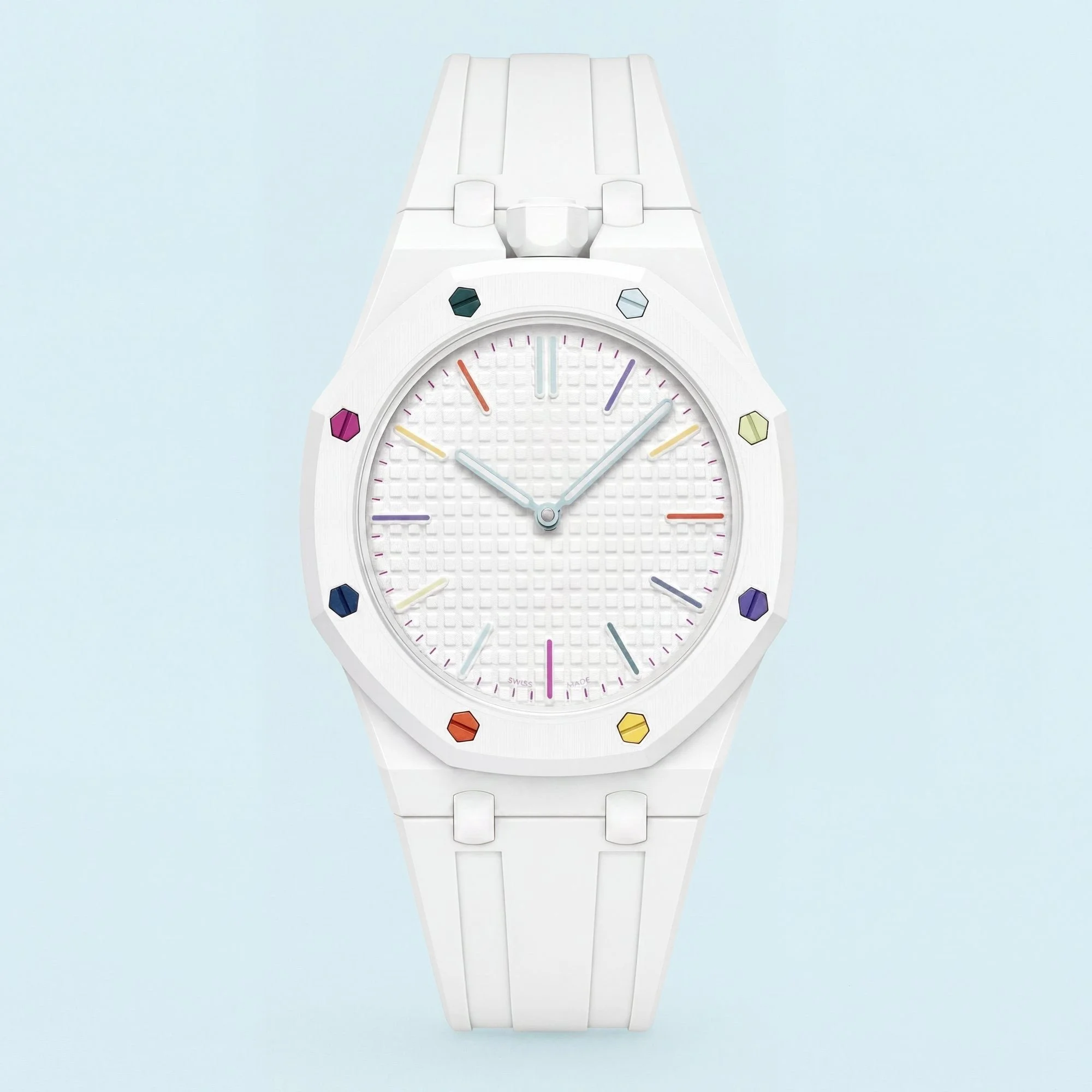 Close-up of a white wristwatch with multicolored hour markers, against a light blue background.