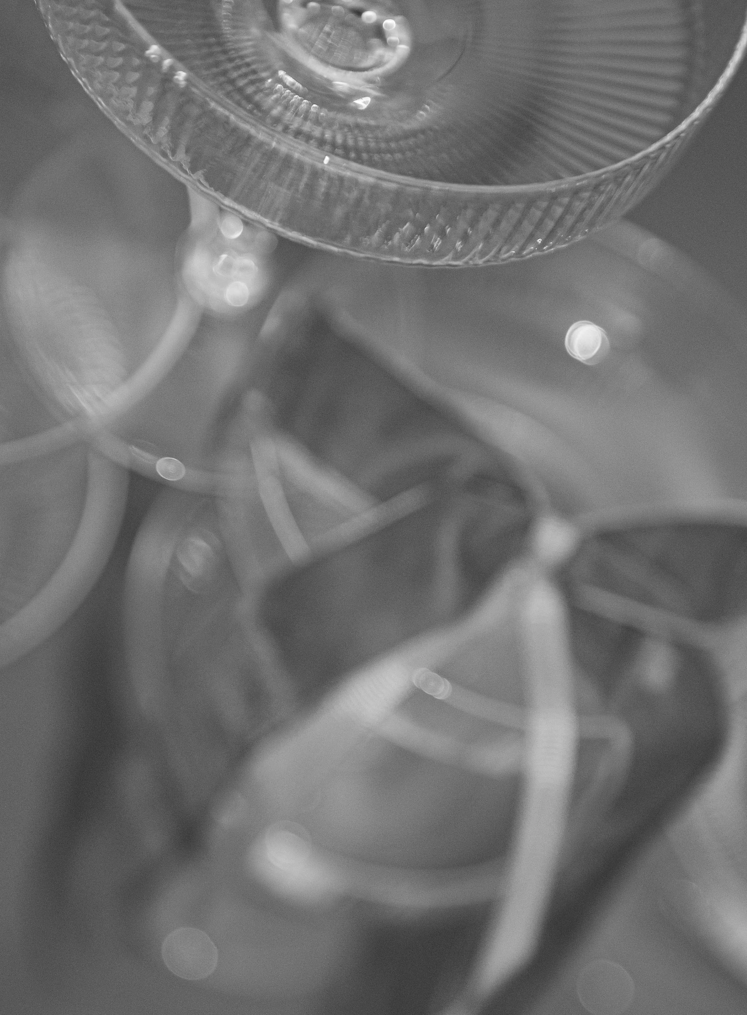 Close-up of a metallic, textured surface with circular and linear patterns, possibly part of a mechanical or industrial object, in grayscale.