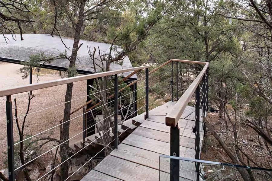 Elevated outdoor deck surrounded by trees at a Colorado treehouse rental