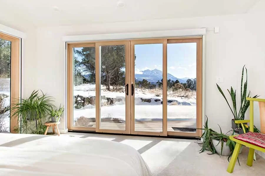Modern mountain living room with comfortable furnishings and expansive windows at High West House