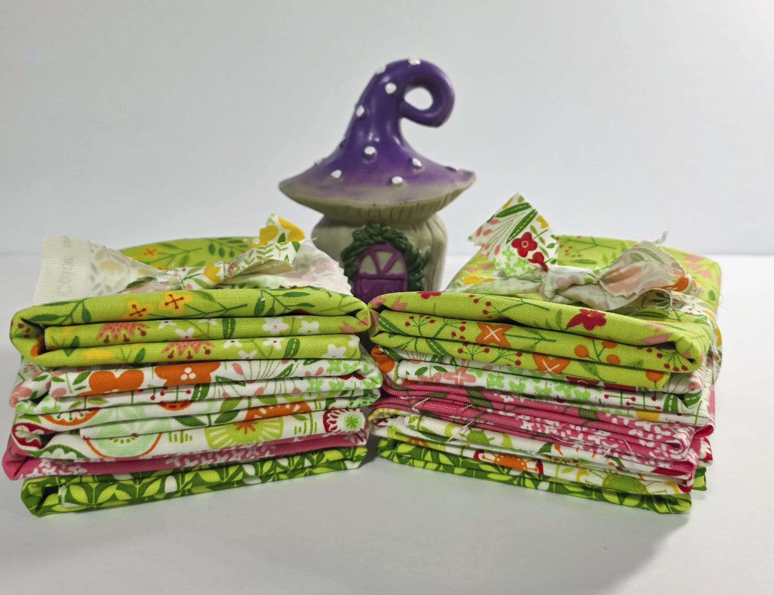 Two fabric bundles with mushroom house in back.jpg