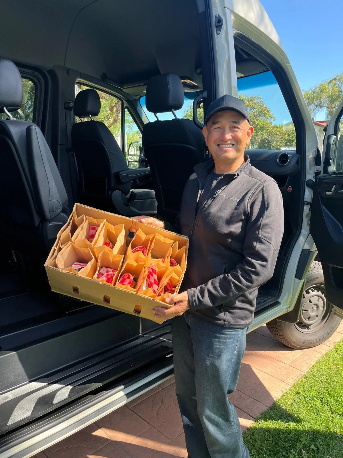 Michael Morabe shows ministry bags to be given to active-duty personnel and volunteers being transported in Morabe Military Ministry 12-seat van.