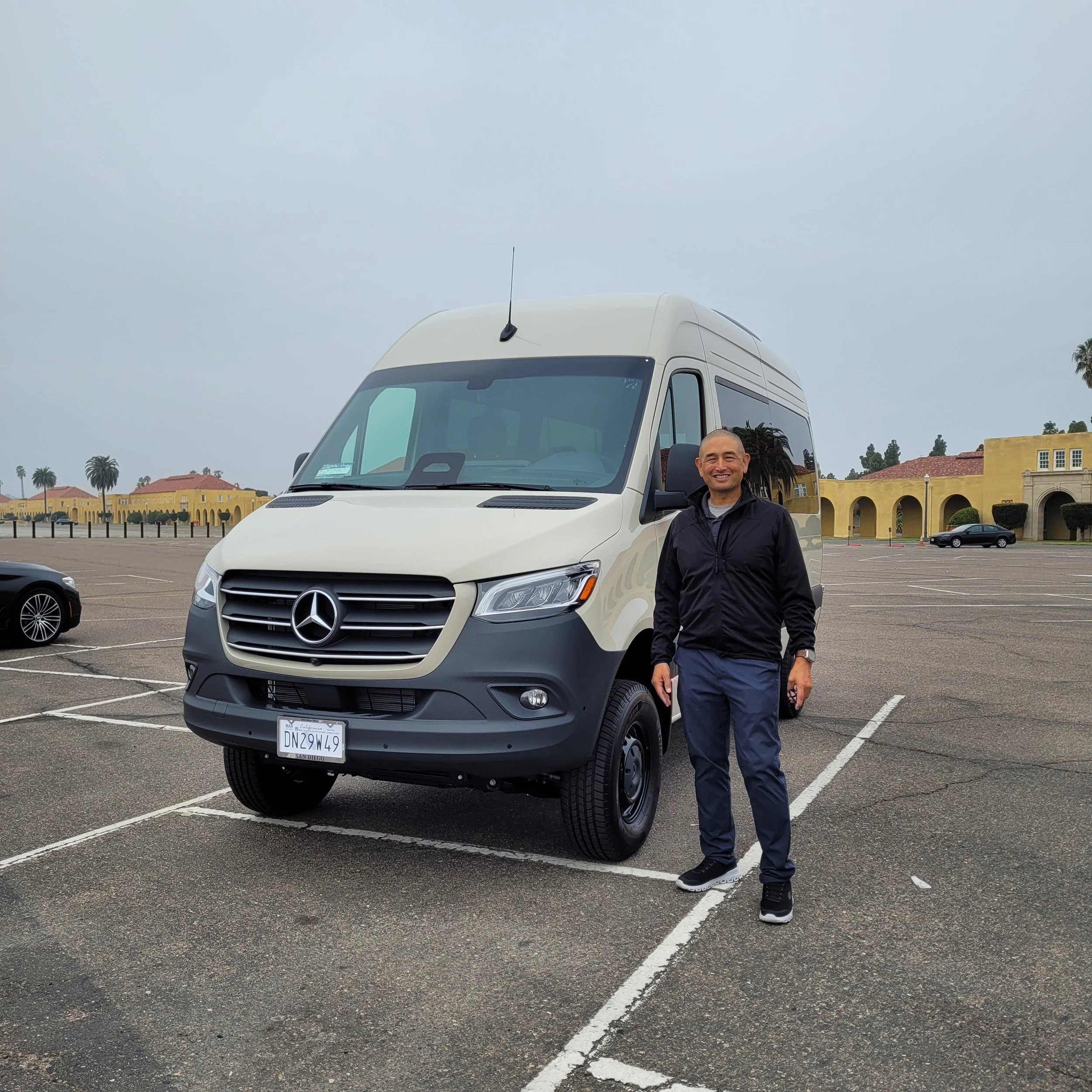 Michael Morabe stands next to the recently purchased 12-seat passenger van that transports wounded warriors in transition and active-duty service members to church and special events.