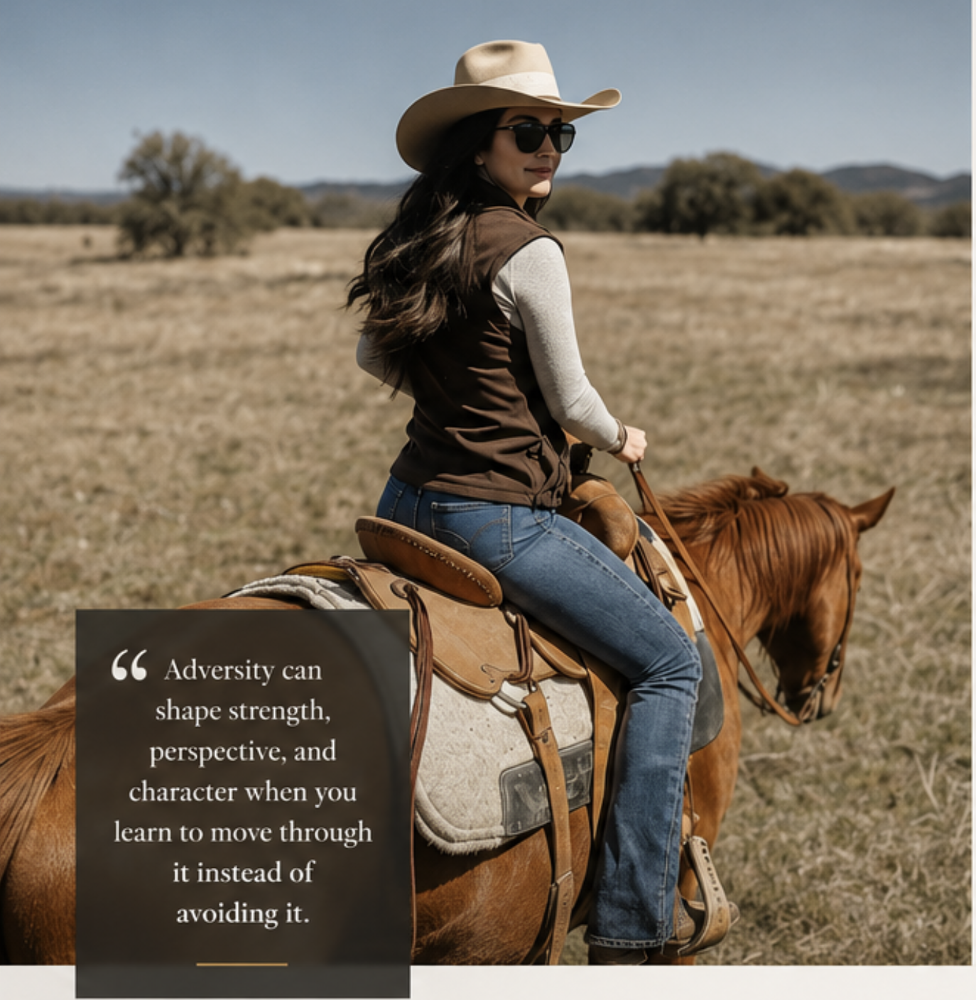 A woman wearing sunglasses, a cowboy hat, a brown vest, and blue jeans riding a brown horse across a grassy open field with trees and hills in the background.