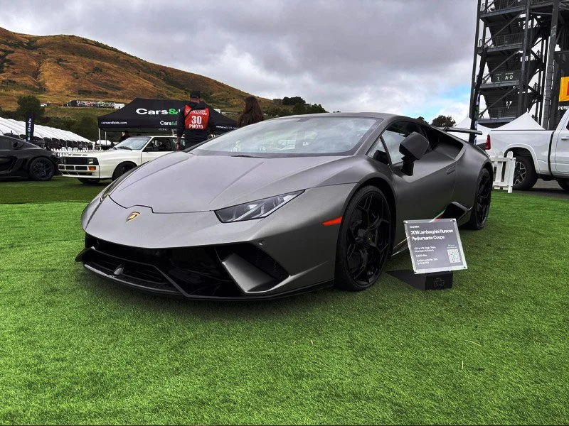 A silver Lamborghini Huracan Performante sports car on display at an outdoor auction in order to attract bidders and bring the highest possible result for your supercar auction